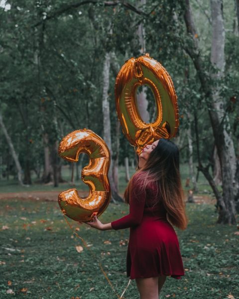 woman in red dress holding gold crown