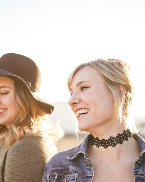 two woman taking a sideview selfie