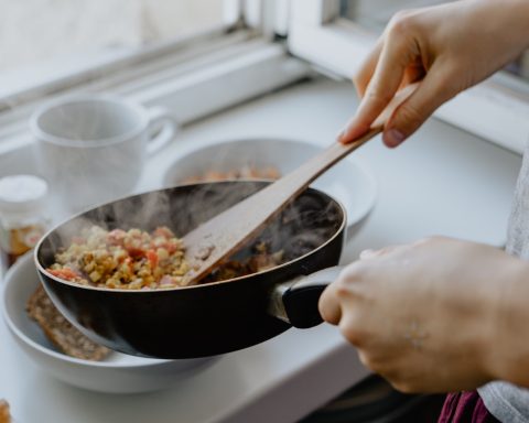 person holding black frying pan