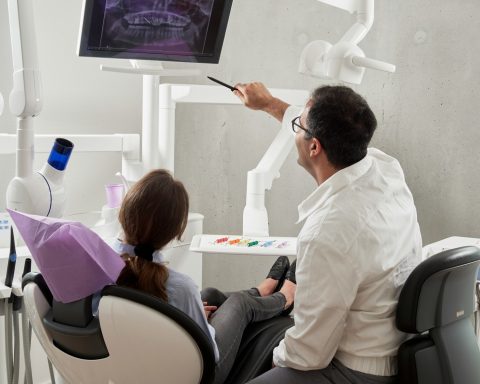 man in white dress shirt holding black pen