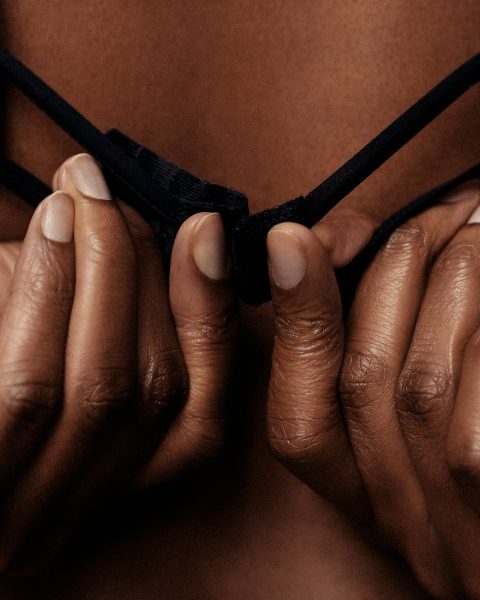 person holding black brassiere strap