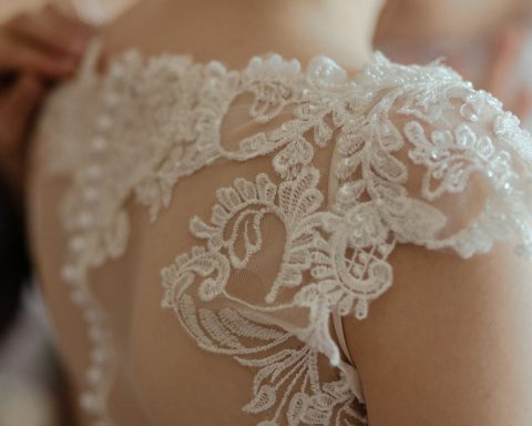 woman wearing white sheer lace wedding gown