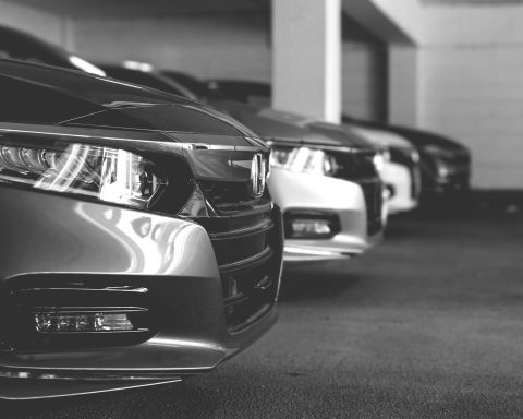grayscale photo of car on road