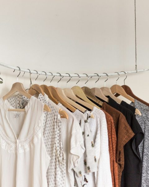 assorted clothes in wooden hangers