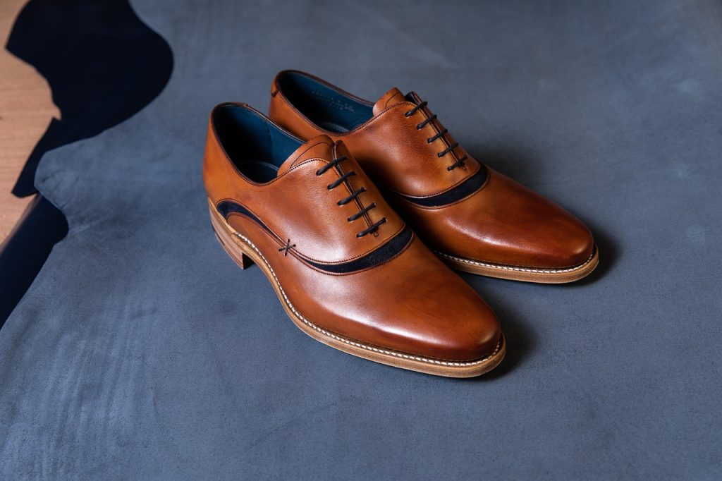 Minimalistische Japanse leren schoenen op een houten ondergrond