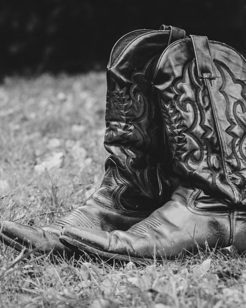 Vrouw die leren boots aanpast in een herfstige omgeving